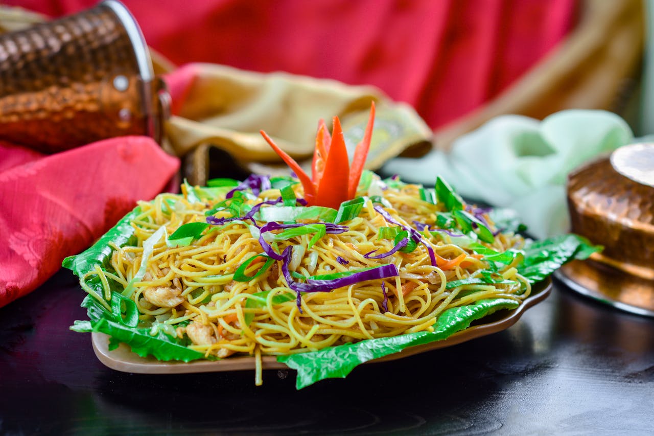 Vibrant noodle dish artistically presented with assorted vegetables, capturing the essence of Asian cuisine.